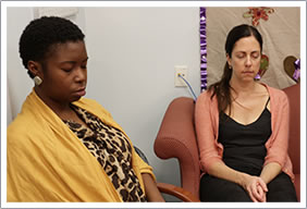 Women meditate together